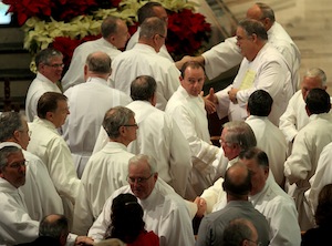 Deacons exchange the sign of peace. (CT File)