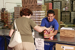 WORKER GATHERS FOOD FOR WOMAN IN 2009 AT CATHOLIC CHARITIES-RUN FACILITY IN NEW YORK
