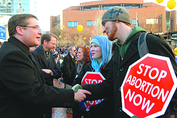 Young married couple greets priest during pro-life rally in Oregon