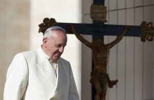 Pope Francis passes a crucifix as he walks down steps during his general audience in St. Peter's Square at the Vatican Dec. 4. (CNS photo/Paul Haring) (Dec. 4, 2013) See POPE-AUDIENCE Dec. 4, 2013.