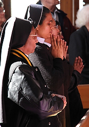 Nun prays during Mass for first group of Teresian Carmelites in India dispatched to U.S.