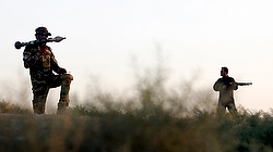 Volunteer Iraqi Shiite militia members stand guard against Islamic State militants