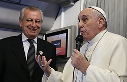 Pope Francis refers to Alberto Gasparri, left, papal trip planner, while answering a question from a French journalist aboard his flight to Manila, Philippines, Jan. 15. In response to the French reporter's question about freedom of religion and freedom of expression, the pope offered a hypothetical example of how Gasparri would receive a punch if he said a swear word against the pope's mother. (CNS photo/Paul Haring) See POPE-PRESS (UPDATED) Jan. 15, 2015.