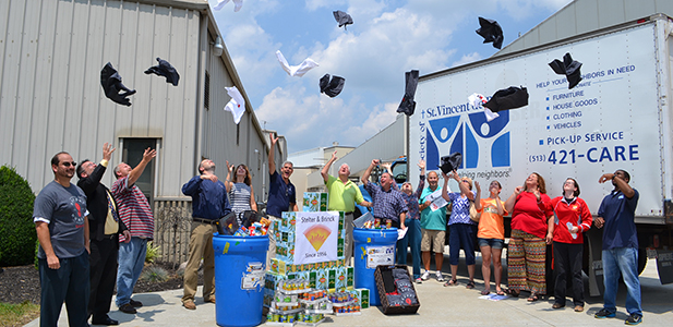 Representatives of Stelter and Brinck, JTM Food Group, and various Catholic institutions celebrate the kick off event of the Food for All campaign Tuesday at the Stelter and Brinck offices in Harrison, Ohio. (CT Photo/John Stegeman)