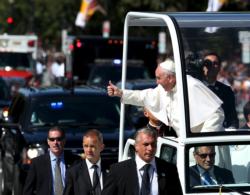 Pope Francis gives a thumbs up to the crowd as he rides down Constitution Avenue in his popemobile in Washington Sept. 23, day two of his first visit to the United States. (CNS photo/Gary Cameron, Reuters)