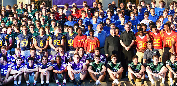 Catholic high school football teams from the southern parts of the Archdiocese of Cincinnati pose for a group photo with Archbishop of Cincinnati Dennis M. Schnurr after the SportsLeader Rosary Rally earlier this summer at the Athenaeum. Week two of the high school football season starts tonight. (CT Photo/John Stegeman)