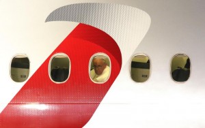 Pope Francis looks out a window after boarding an American Airlines jetliner at Philadelphia International Airport Sept. 27 for his return to Rome following a six-day apostolic visit to the U.S. (CNS photo/Gregory A. Shemitz)