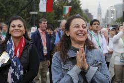 A woman reacts to Pope Francis' final words during the closing Mass of the World Meeting of Families on the Benjamin Franklin Parkway in Philadelphia Sept. 27. (CNS photo/Brian Snyder, Reuters)