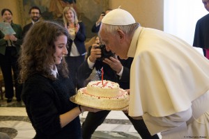 Pope Francis blows out the candle on a birthday cake presented by a young member of the Italian branch of Catholic Action during an audience with the group at the Vatican Dec. 17. The pope celebrated his 79th birthday Dec. 17. (CNS photo/L'Osservatore Romano, handout)