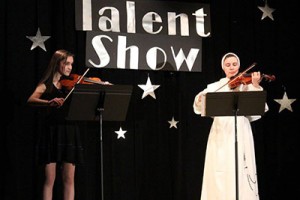 St. Gertrude eighth grader Olivia DeStefano and Junior High teacher Sister Veronica Marie, O.P. perform in a Catholic Schools Week Talent Show.