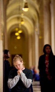 Ashley Steffes, a student at Franciscan University in Steubenville, Ohio, kneels to pray. (CNS photo/Mike Crupi, Catholic Courier)