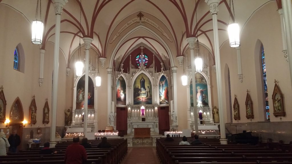 After the climb, the faithful sit and pray in silence inside Holy Cross Immaculata Church. (Greg Hartman/CT Photo)