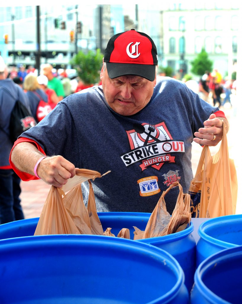 St. Vincent de Paul volunteer Steve Taylor places bags of donated food into a collection bin outside of Great American Ballpark on Friday, May 31. SVdP collected food from patrons of the Reds games on Friday and Saturday, May 31 and June 1, during their “Strike Out Hunger" campaign. Game patrons who donated three or more non-perishable foods were awarded tickets to a future Reds game. Last year’s drive collected over three tons of food, which fed approximately 5,300 families. (CT photo/David A. Moodie)