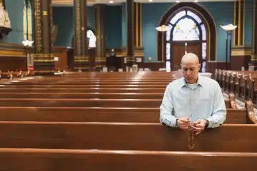 David Cooley, editorial director of The Catholic Telegraph, prays the Rosary at St. Xavier Church