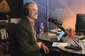 Man smiling with headphones on radio